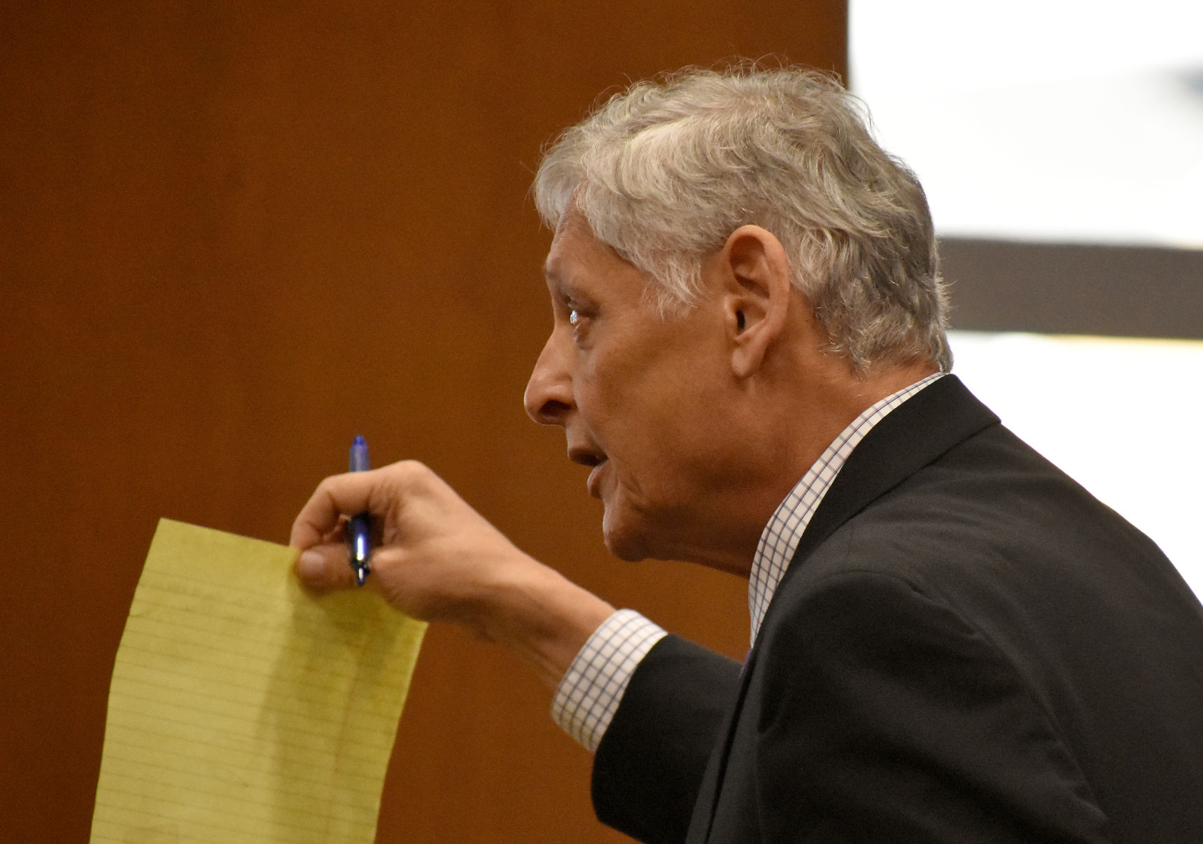 Benavides holds up sheet of paper